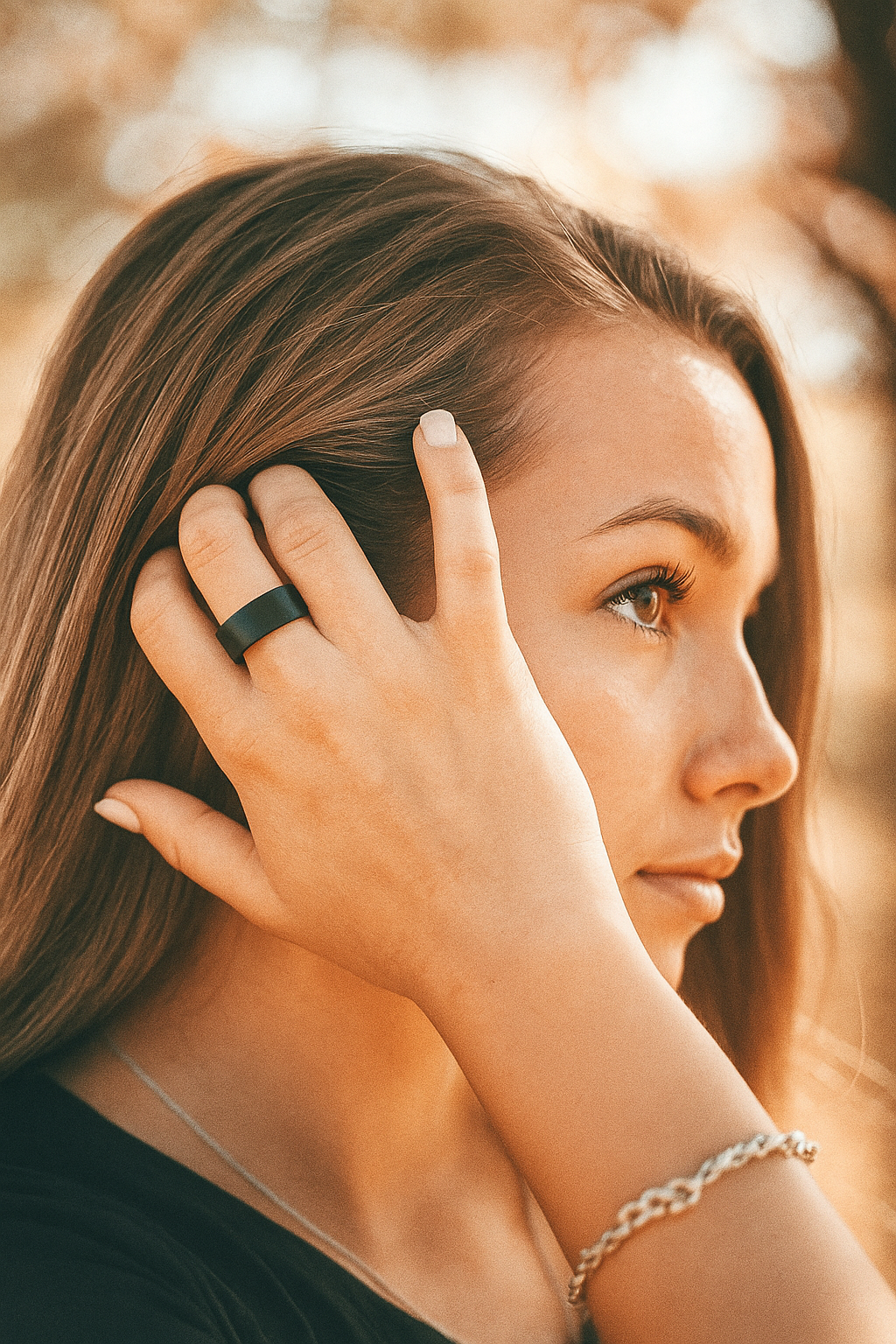 Women moving hair to show black aura ring pro