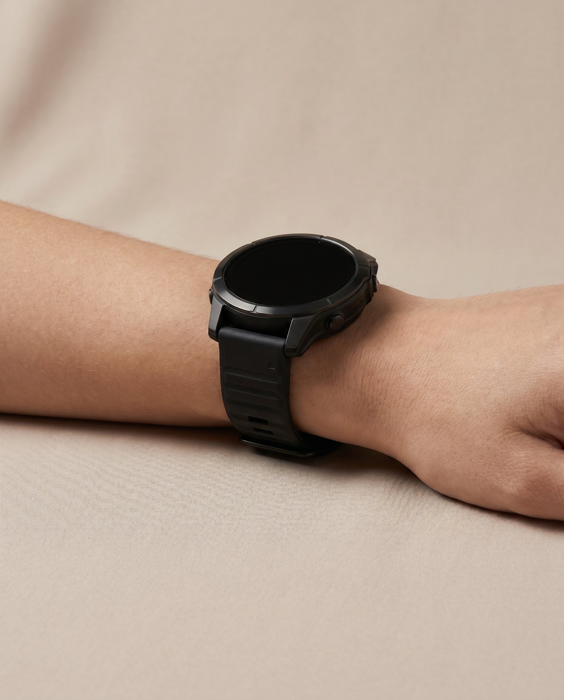 A bulky black smartwatch on a wrist.